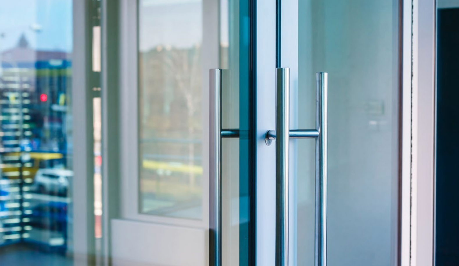 Modern aluminum French doors with metallic handles.