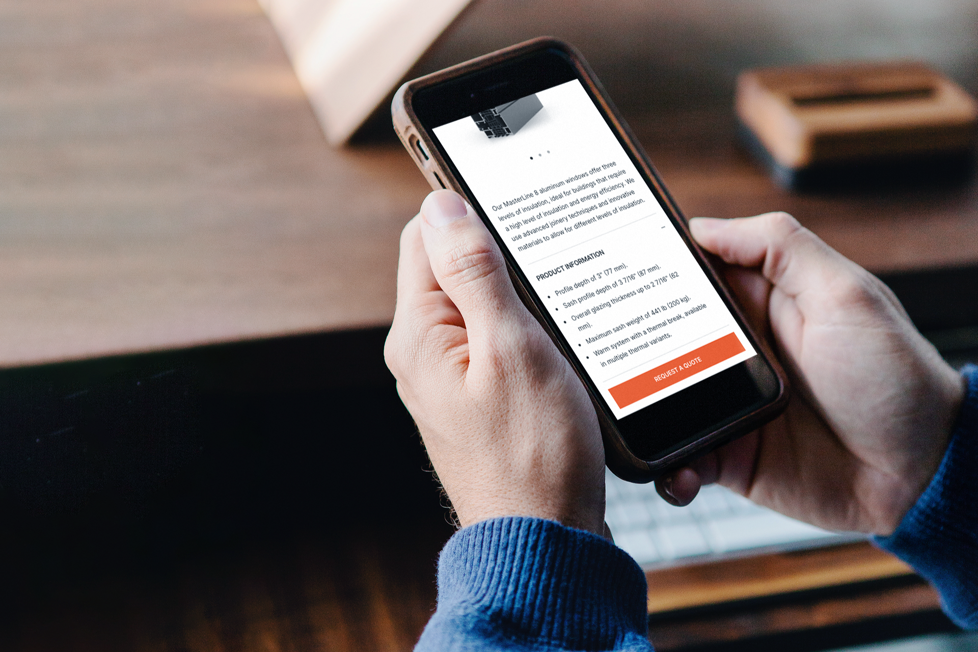 Man holding an iPhone open on the Jesko Windows & Doors website.